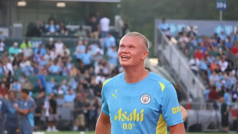 Erling Haaland smiling in a Man City training top