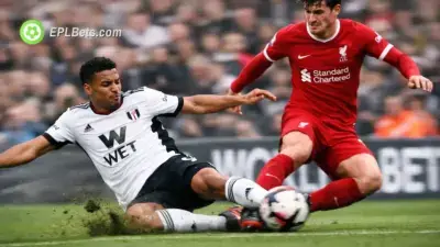 Fulham and Liverpool players contest a sliding tackle