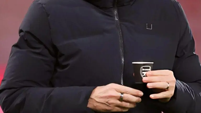 Tottenham manager Thomas Frank drinking from a cup with an Arsenal logo