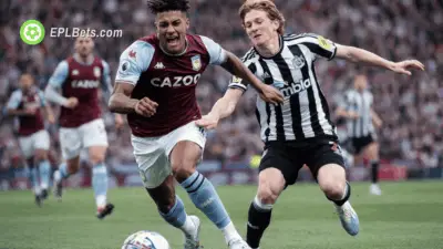 Ollie Watkins of Aston Villa and Anthony Gordon of Newcastle challenge for the ball