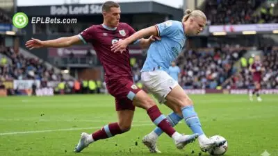 Maxime Esteve and Erling Haaland compete for the ball
