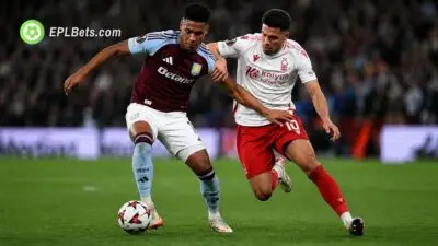 Ollie Watkins and Morgan Gibbs-White duel for the ball.