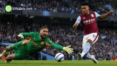 Gianluigi Donnarumma dives to block a shot from Ollie Watkins