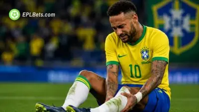 Neymar on ground holding injured calf