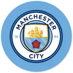 A Manchester City club crest on a sky blue circle