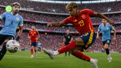 Spain's Lamine Yamal slams home a volley as Ronald Araújo of Uruguay looks on