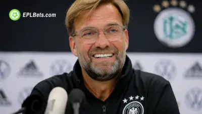 Jürgen Klopp smiling at a press conference as he become new Germany coach