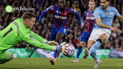Dean Henderson of Crystal Palace making a save from Omar Marmoush of Manchester City