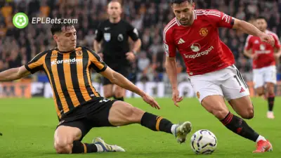 Matt Crooks of Hull City tangles with Mason Mount of Manchester United in midfield