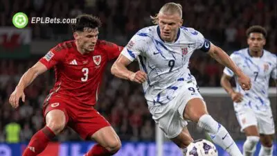 Erling Haaland battles a Wales defender for possession during Norway's UEFA Nations League clash with Wales in Cardiff.