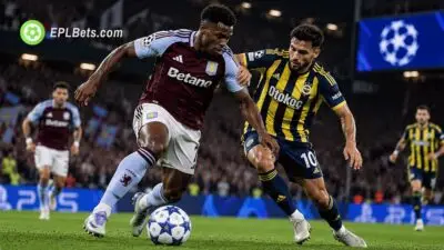 An Aston Villa player dribbles past a Fenerbahce defender during a UEFA Champions League clash at Villa Park.