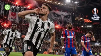 Beşiktaş player celebrates a goal by cupping his ear towards the crowd as Crystal Palace players look dejected during a Europa League match illustration.
