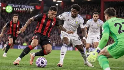 A Bournemouth attacker drives towards goal under pressure from an Aston Villa defender as the goalkeeper rushes out during a Carabao Cup clash at the Vitality Stadium.
