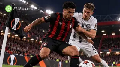 Bournemouth player battles for possession against a Sturm Graz defender beside a UEFA Europa League corner flag at the Vitality Stadium.