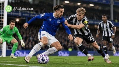 Everton winger Jack Grealish shields the ball from Newcastle United defender Lewis Hall during a Carabao Cup fourth-round clash at the Hill Dickinson Stadium.