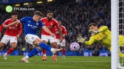 Ipswich Town attacker fires a shot towards goal as the Nottingham Forest goalkeeper dives to make a save, with Forest defenders looking on during a Premier League match illustration.