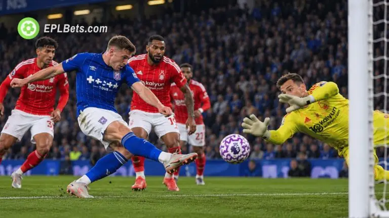 Ipswich Town attacker fires a shot towards goal as the Nottingham Forest goalkeeper dives to make a save, with Forest defenders looking on during a Premier League match illustration.