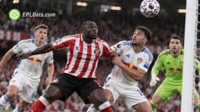 Sunderland striker Brian Brobbey battles with a Leeds United defender for an aerial ball inside the penalty area during a Premier League match at the Stadium of Light.